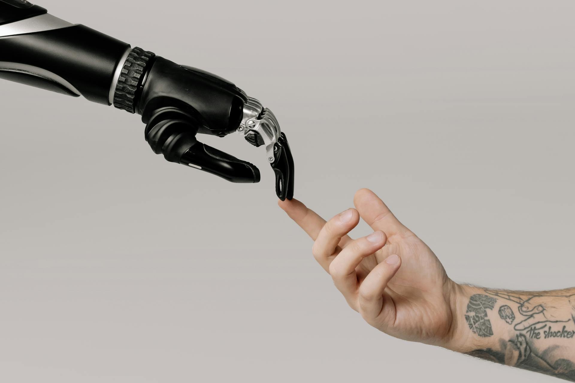 robot hand reaches for a human hand